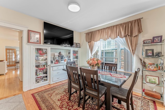 dining space with light hardwood / wood-style flooring