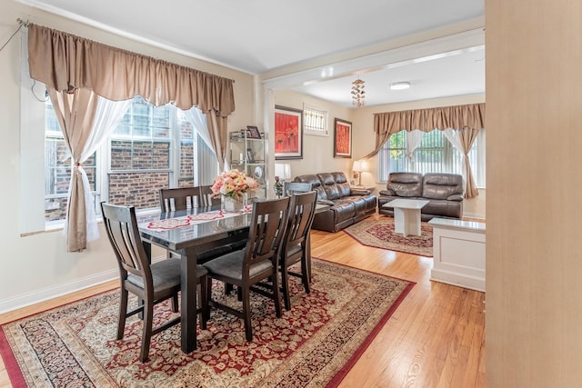 dining area with light wood-type flooring and a wealth of natural light