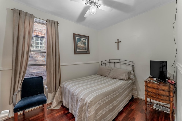 bedroom featuring ceiling fan and dark wood-type flooring