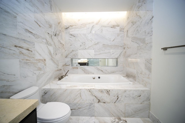 bathroom featuring vanity, toilet, tile walls, and tiled tub