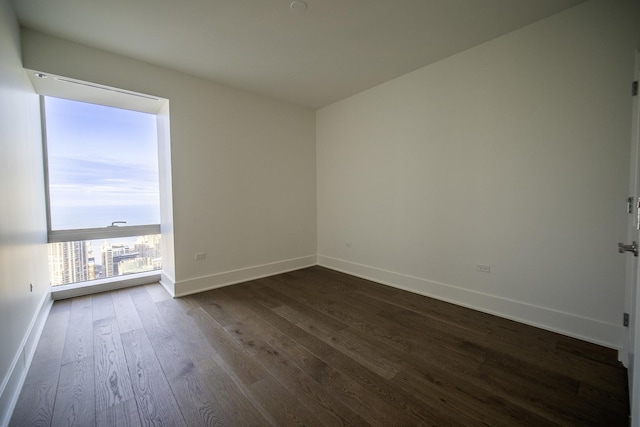 unfurnished room with dark hardwood / wood-style floors