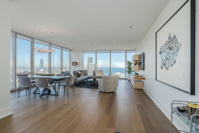 living area with expansive windows and wood finished floors