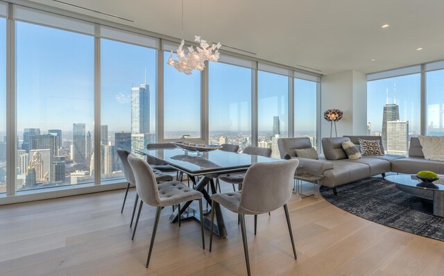 sunroom / solarium featuring a view of city and a notable chandelier
