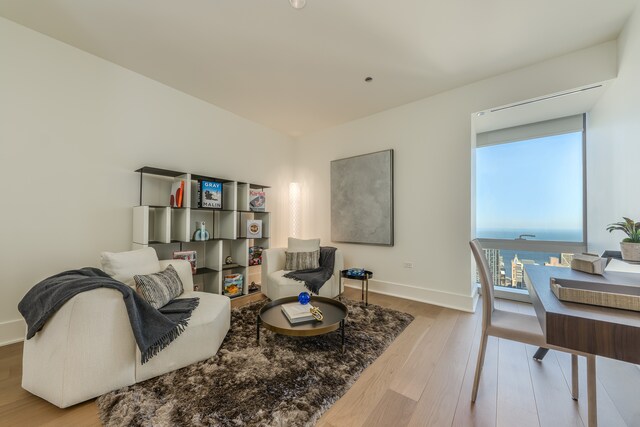sitting room featuring baseboards and wood finished floors