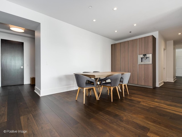 dining space with dark hardwood / wood-style floors