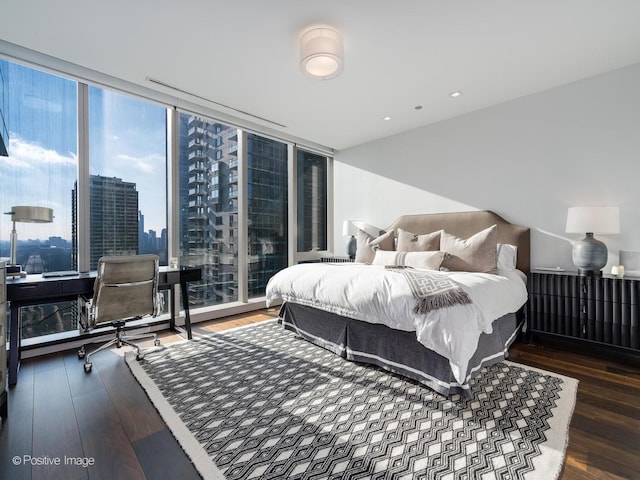 bedroom with floor to ceiling windows and dark wood-type flooring