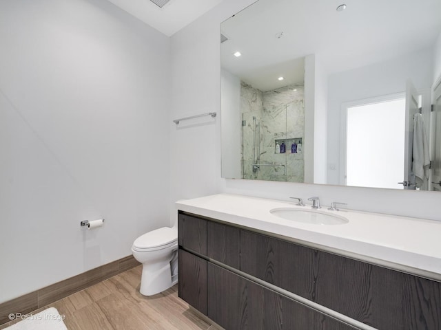 bathroom featuring vanity, toilet, and walk in shower