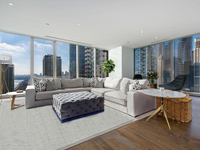 living room with wood-type flooring and expansive windows