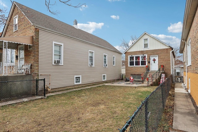 rear view of property featuring a yard and a patio