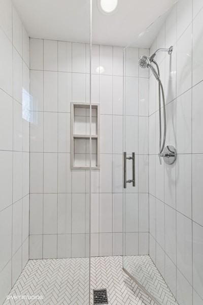 bathroom featuring a shower with shower door