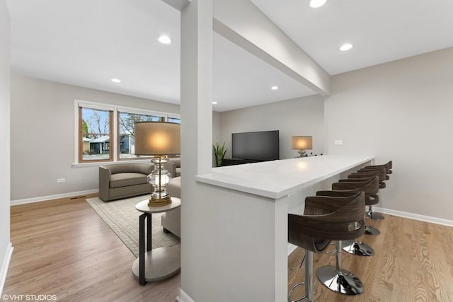 bar featuring light hardwood / wood-style floors