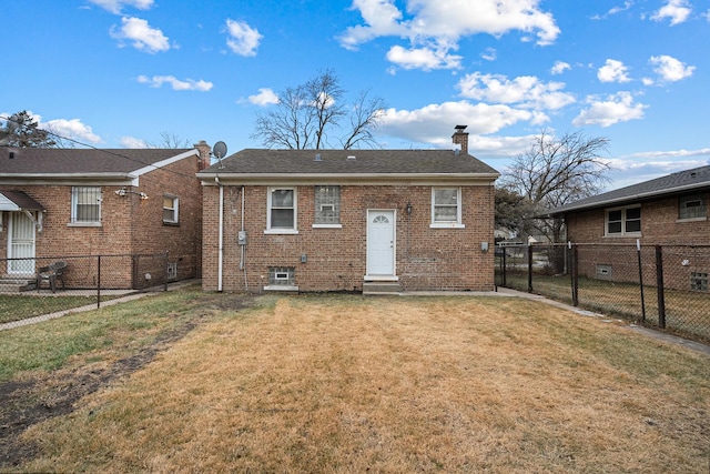 back of property featuring a yard