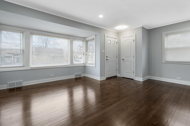 interior space featuring ornamental molding and dark hardwood / wood-style flooring