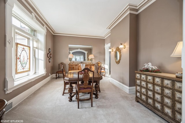 dining area featuring light colored carpet and ornamental molding