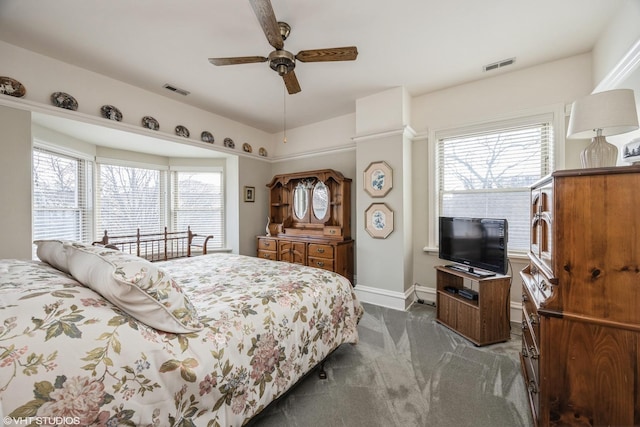 carpeted bedroom featuring ceiling fan and multiple windows