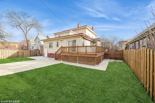 rear view of house with a yard and a deck