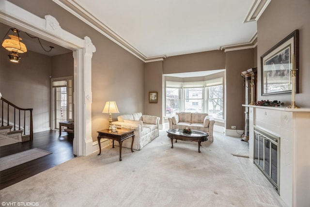 carpeted living room featuring a healthy amount of sunlight and ornamental molding