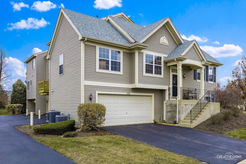 view of front of property featuring cooling unit and a garage