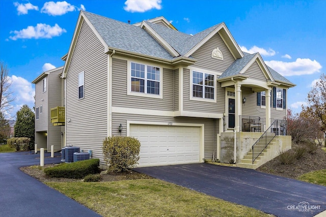 view of front of property featuring cooling unit and a garage