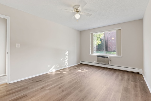 spare room featuring a textured ceiling, light hardwood / wood-style floors, baseboard heating, and ceiling fan