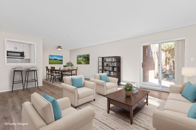 living room featuring light hardwood / wood-style floors and baseboard heating