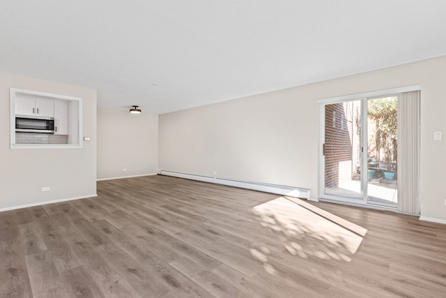 unfurnished living room with light hardwood / wood-style floors and a baseboard radiator