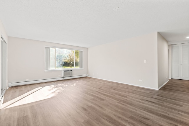 unfurnished living room featuring a baseboard radiator, a textured ceiling, and hardwood / wood-style flooring