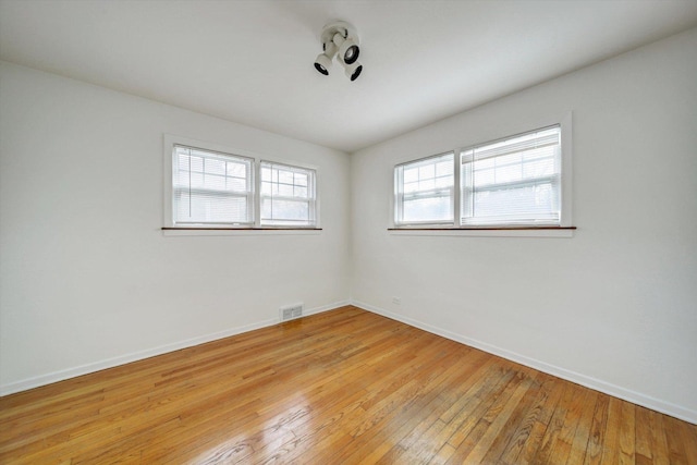 unfurnished room with light wood-type flooring