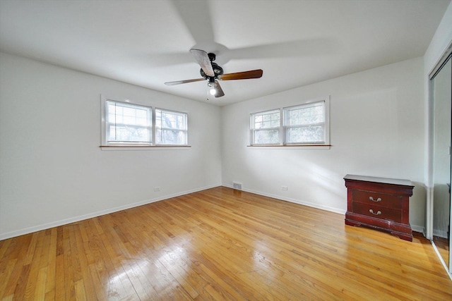 unfurnished bedroom with ceiling fan and light hardwood / wood-style flooring