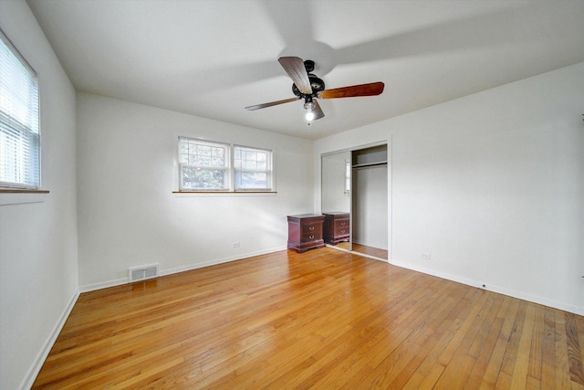 unfurnished bedroom featuring ceiling fan, a closet, and light hardwood / wood-style floors