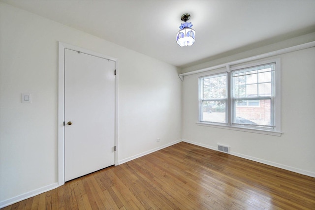 empty room with wood-type flooring