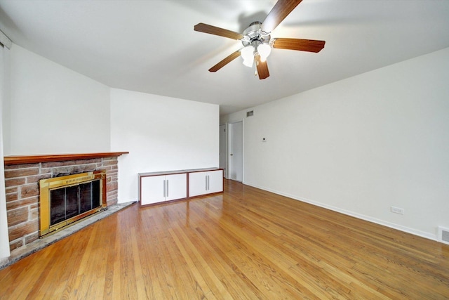 unfurnished living room featuring ceiling fan and hardwood / wood-style floors