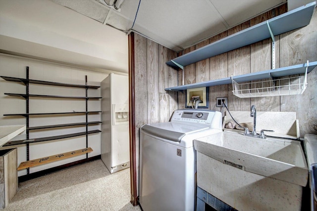 laundry room with washer / clothes dryer, wooden walls, and light colored carpet