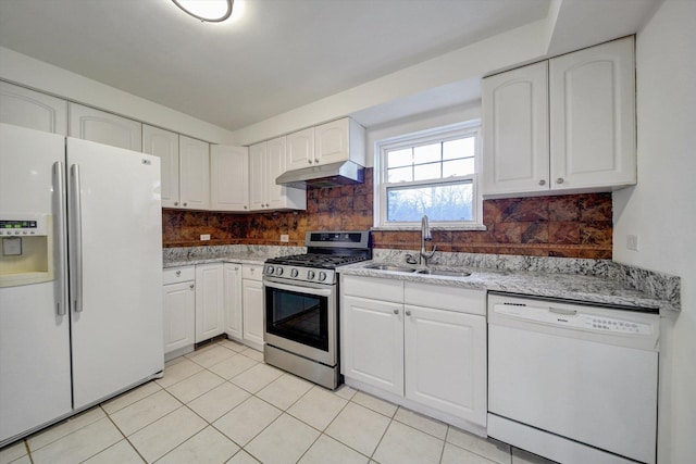 kitchen featuring sink, light tile patterned flooring, backsplash, white appliances, and white cabinets