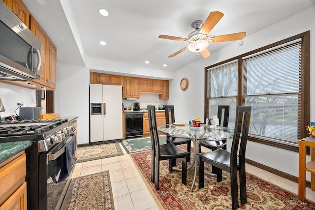 kitchen with ceiling fan, light tile patterned floors, and stainless steel appliances