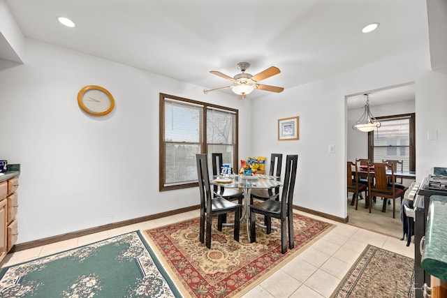 tiled dining area with ceiling fan