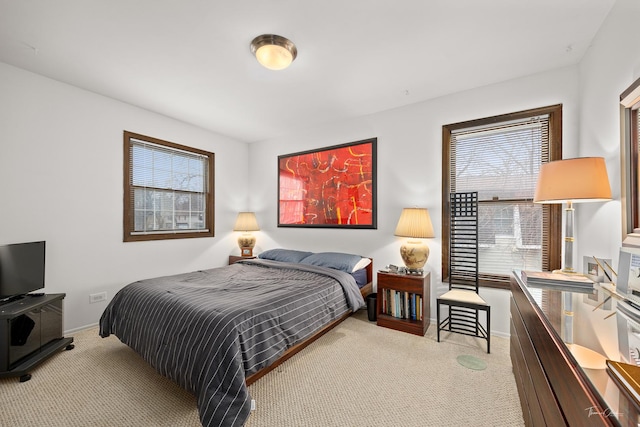 carpeted bedroom featuring multiple windows