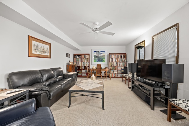 carpeted living room with ceiling fan