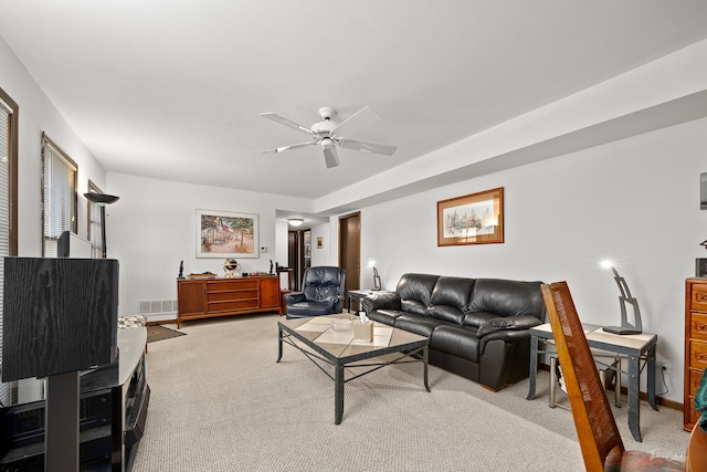 living room featuring light colored carpet and ceiling fan