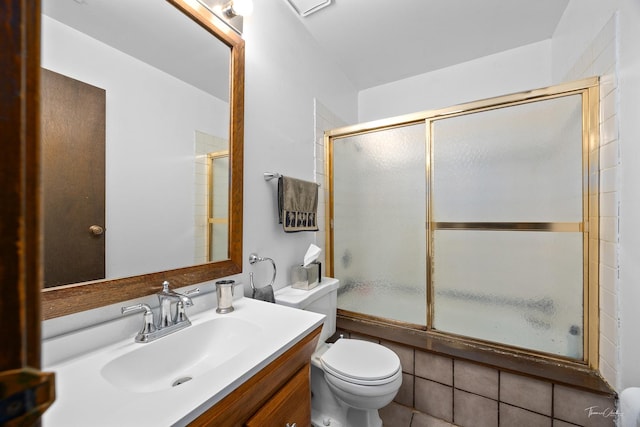 bathroom featuring tile patterned floors, vanity, and toilet