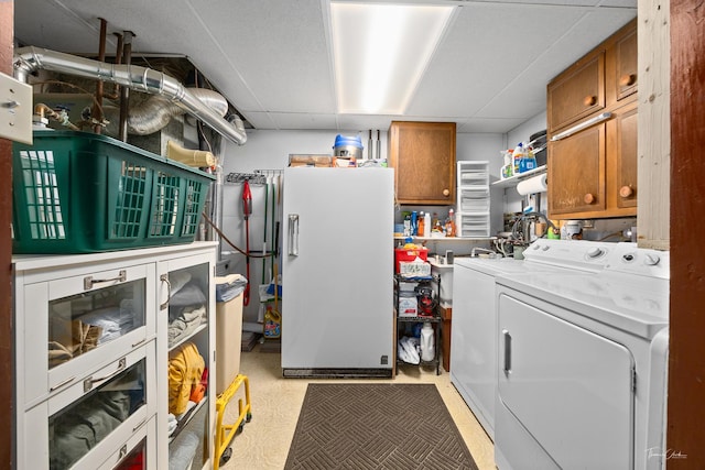 laundry area featuring washer and clothes dryer and cabinets