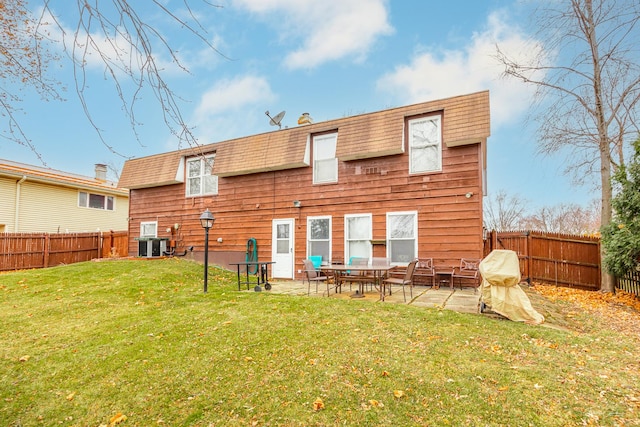 rear view of house featuring a yard, a patio, and cooling unit