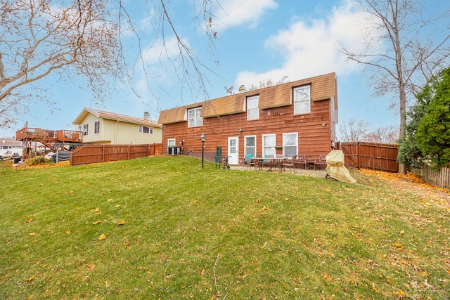 rear view of house with a yard and a patio