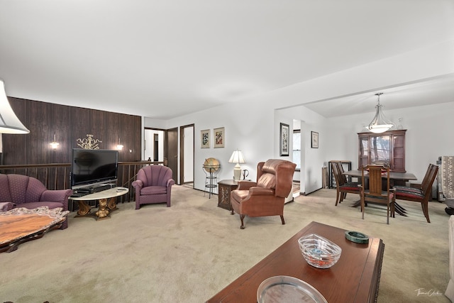 living room with light carpet and wood walls