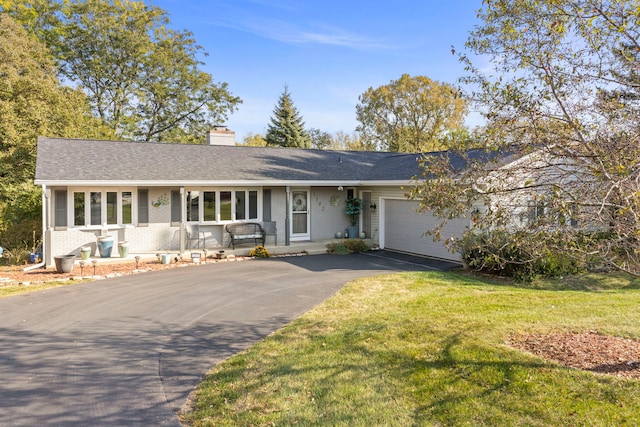 single story home featuring a front yard and a garage