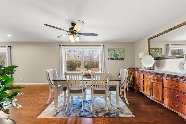 dining area with dark hardwood / wood-style flooring and ceiling fan