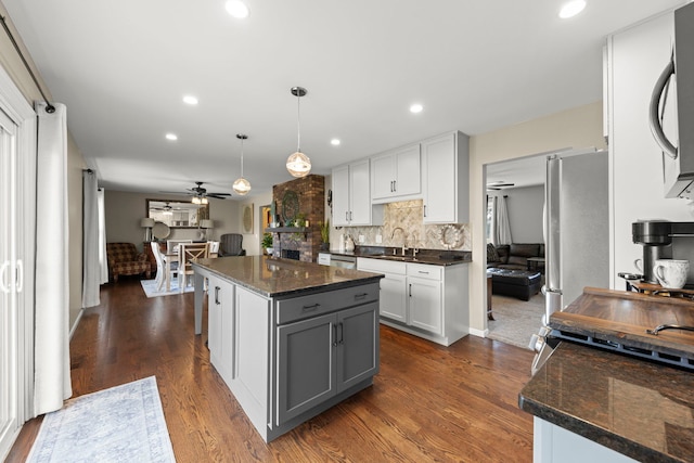 kitchen featuring a kitchen island, ceiling fan, gray cabinets, white cabinetry, and hanging light fixtures