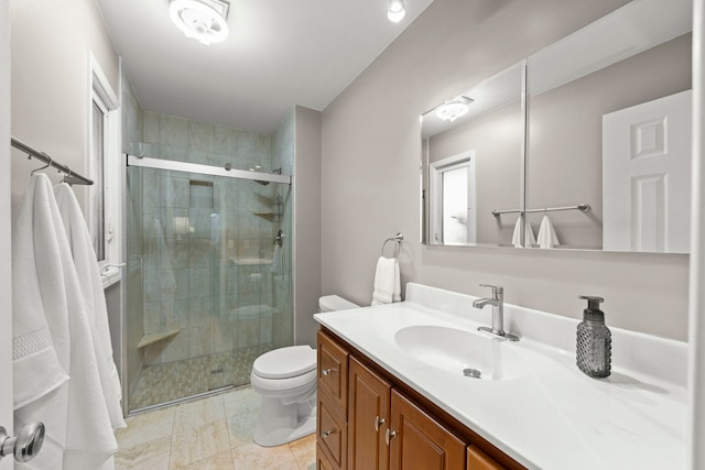 bathroom with tile patterned flooring, vanity, toilet, and walk in shower