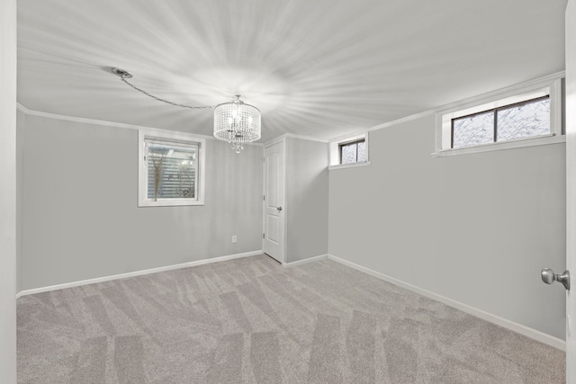 carpeted empty room with an inviting chandelier and crown molding