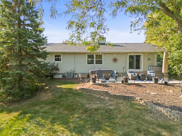 rear view of house with a lawn, an outdoor living space, cooling unit, a jacuzzi, and a patio